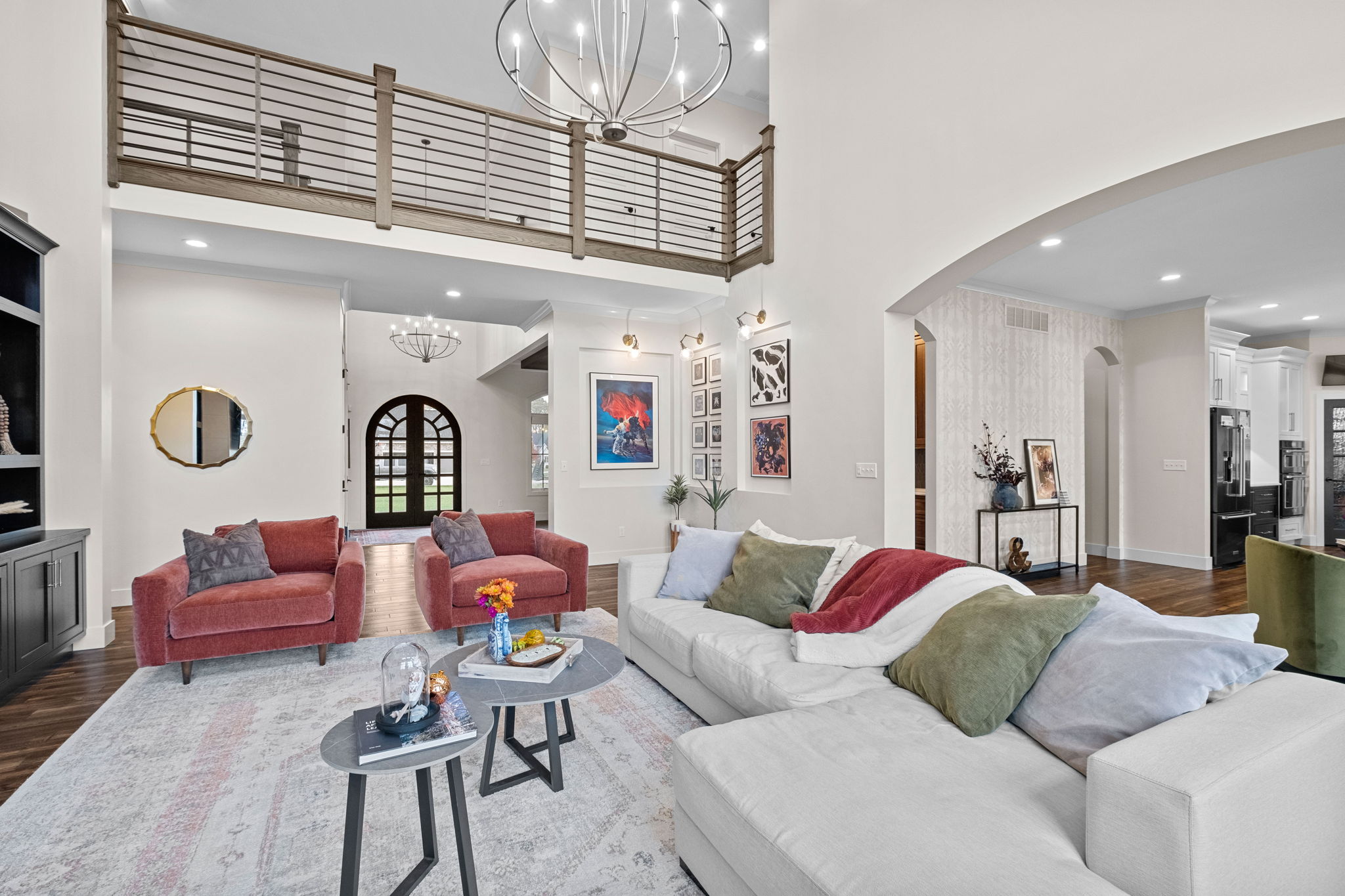 A great room boasts 14+ foot ceilings and a large, two-story tiled fireplace.