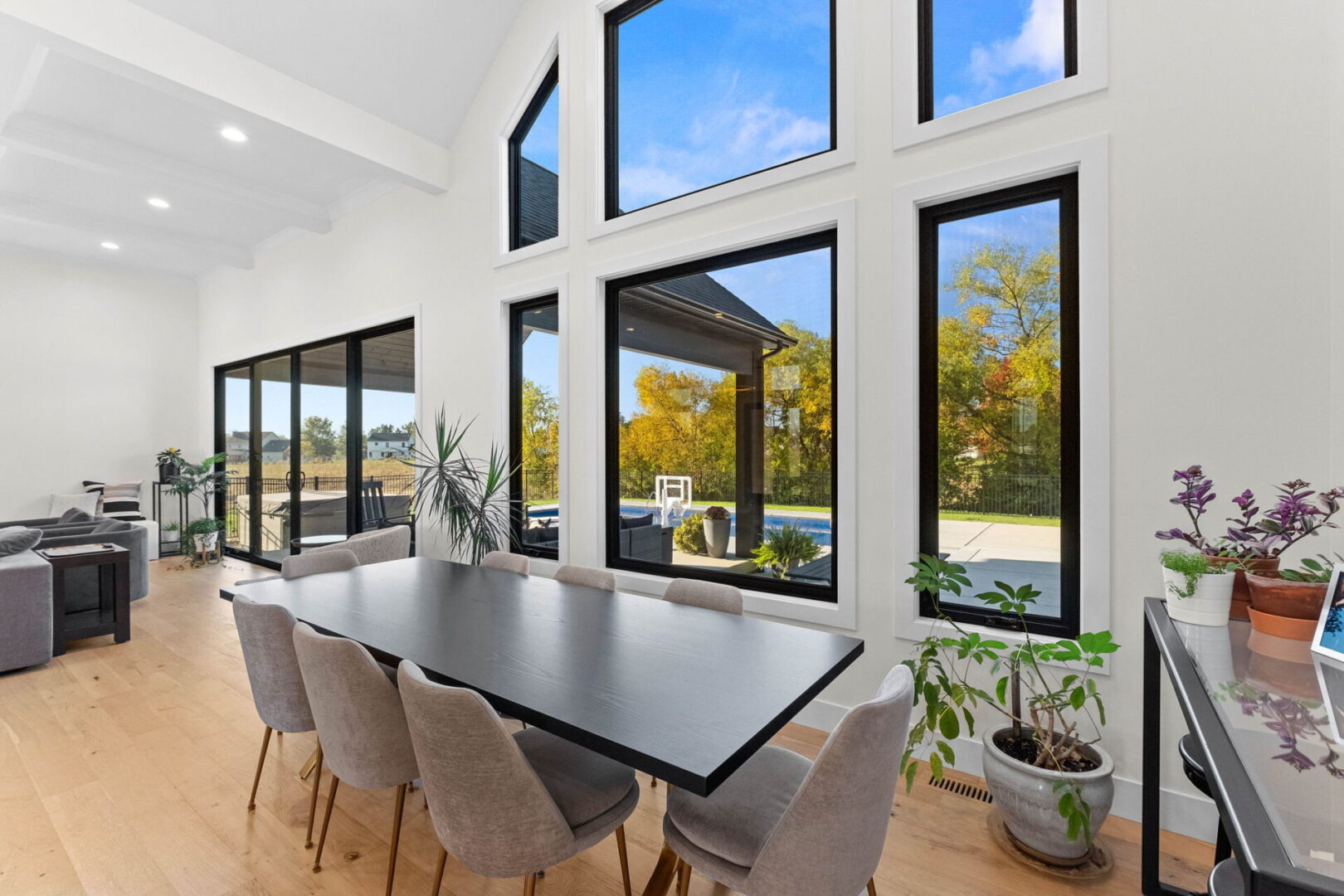 Large dining room featuring an expansive wall of windows, offering a modern twist.