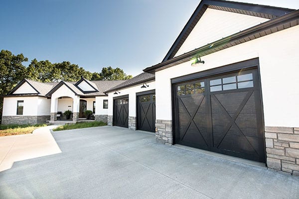 A modern farmhouse design featuring white brick and stone wainscoting, complemented by a ranch-style floor plan.