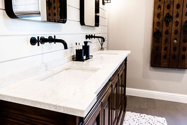 A primary bathroom featuring rustic elements and a shiplap wall design.