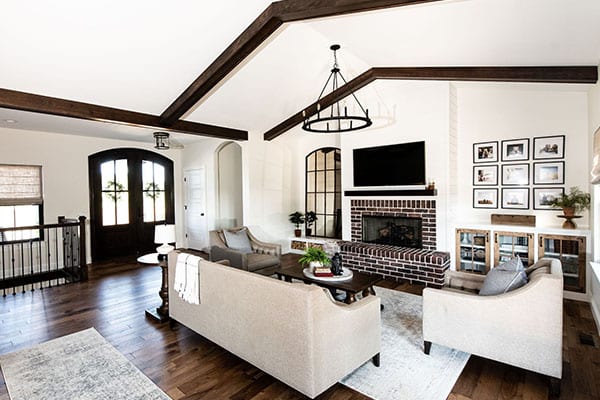 An elegant, modern farmhouse with an open floor plan features a kitchen that seamlessly transitions into the dining room and great room. pioneer ridge