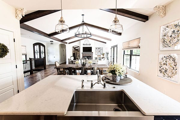 An elegant, modern farmhouse with an open floor plan features a kitchen that seamlessly transitions into the dining room and great room. pioneer ridge