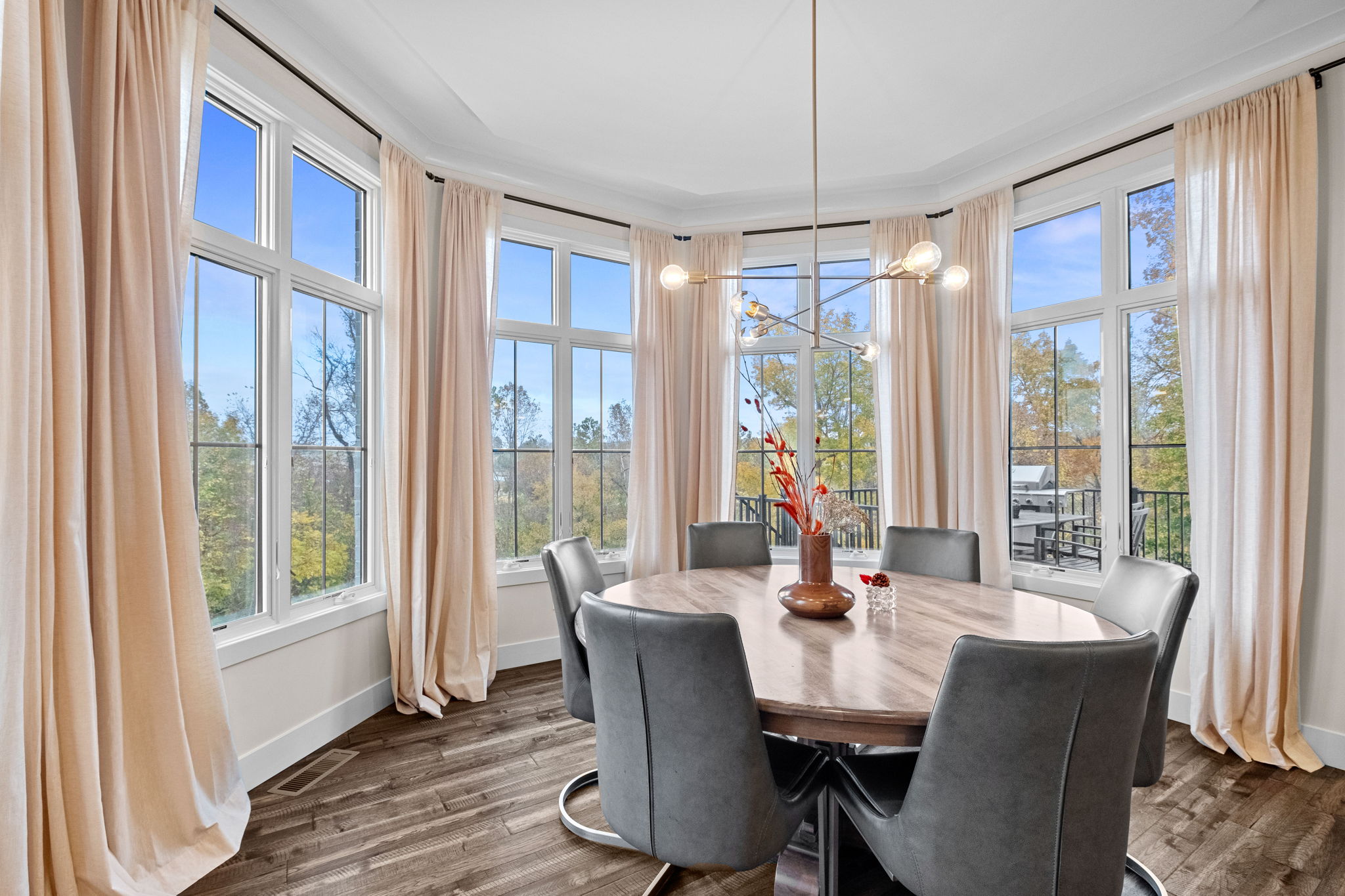 A bay window complements the dining room, enhanced by an elegant drop ceiling.
