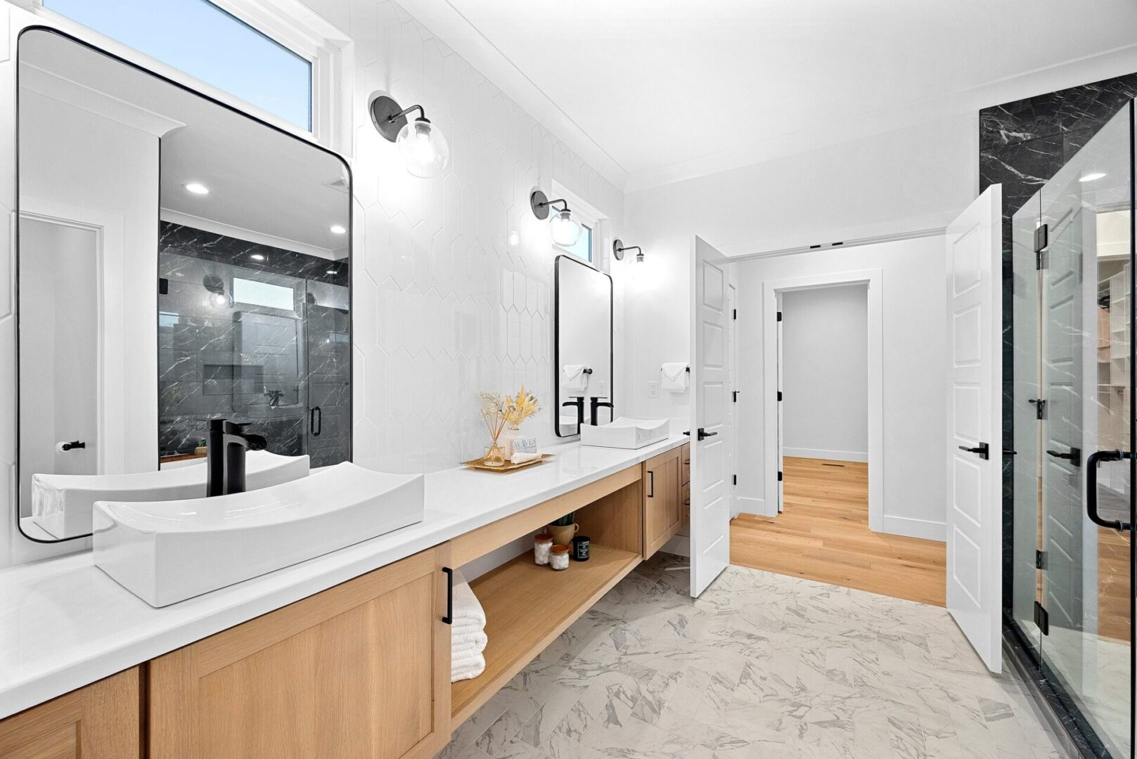 A modern floating Shiloh vanity adorned with gold hardware and fixtures, complemented by intricately laid picket tile.