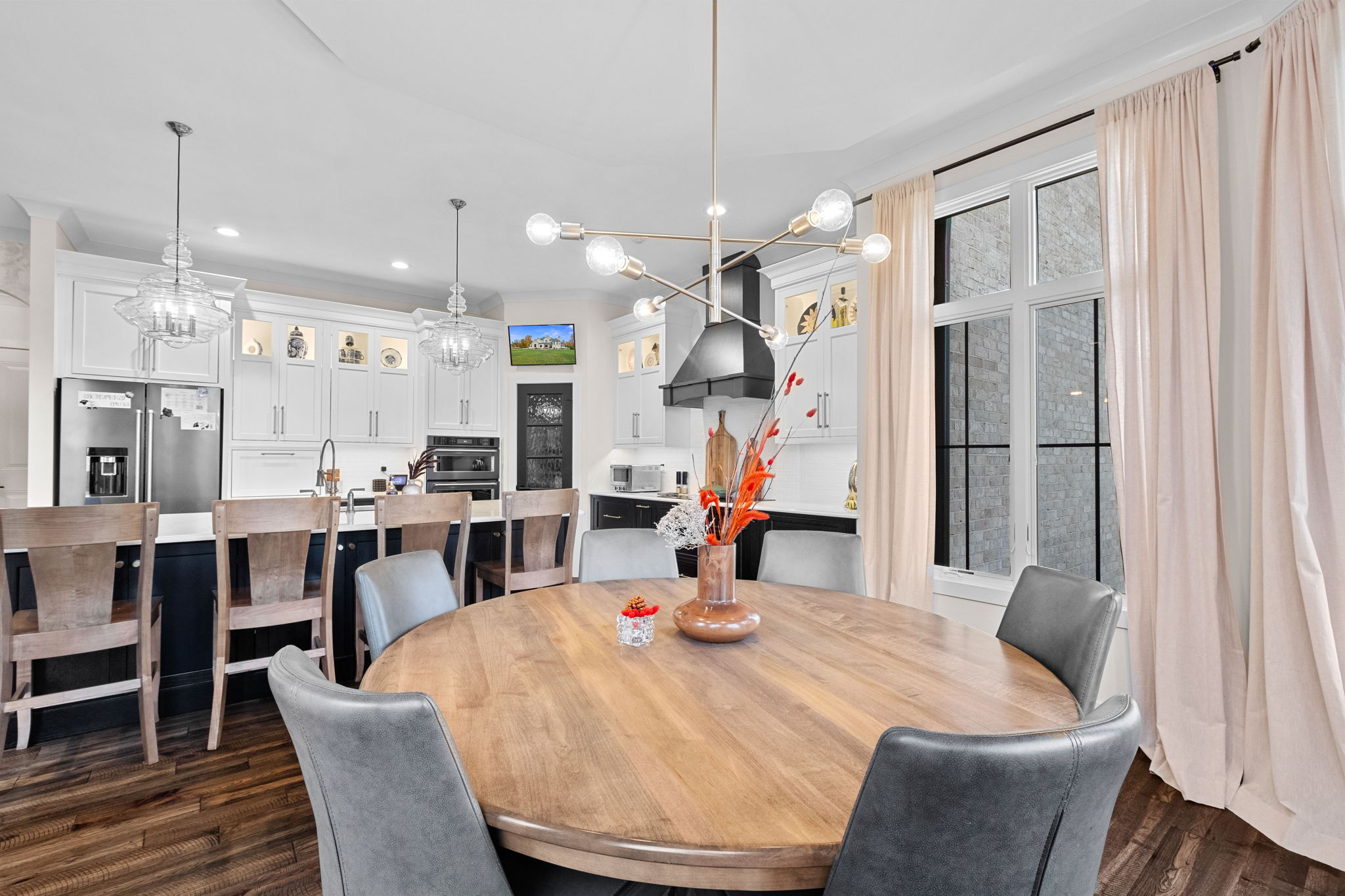The home features a rear view of the European style, complete with stone and EIFS. It boasts large back decks accessible from the kitchen and a private deck adjoining the primary bedroom suite.