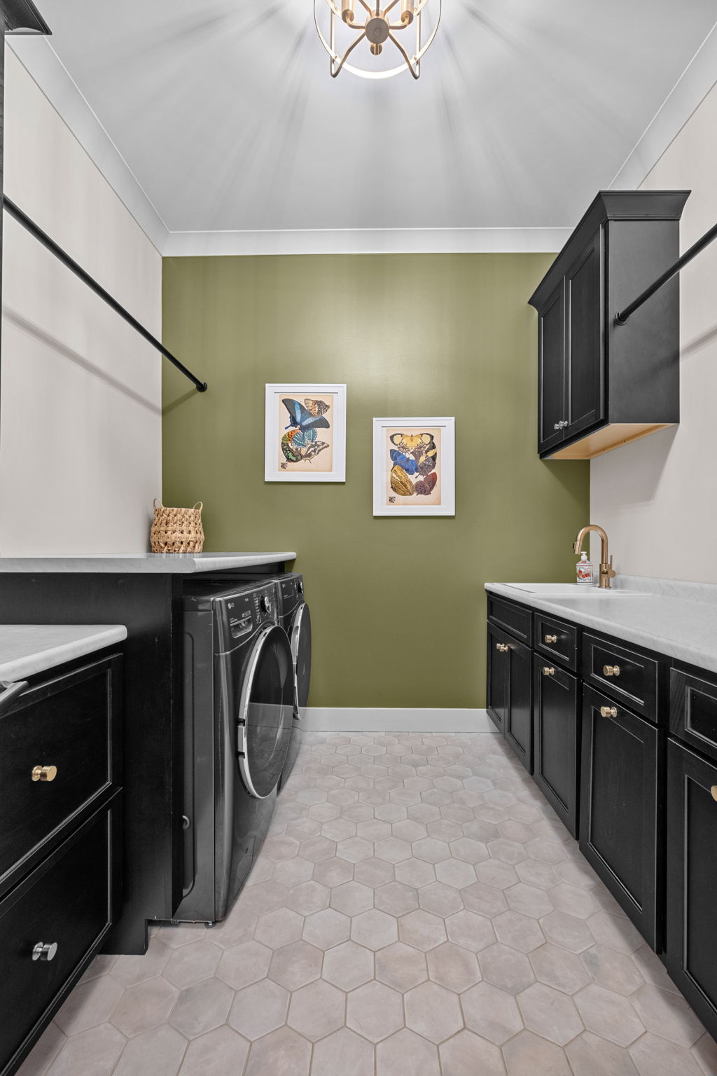 A laundry room featuring custom Shiloh cabinets and tiled flooring.