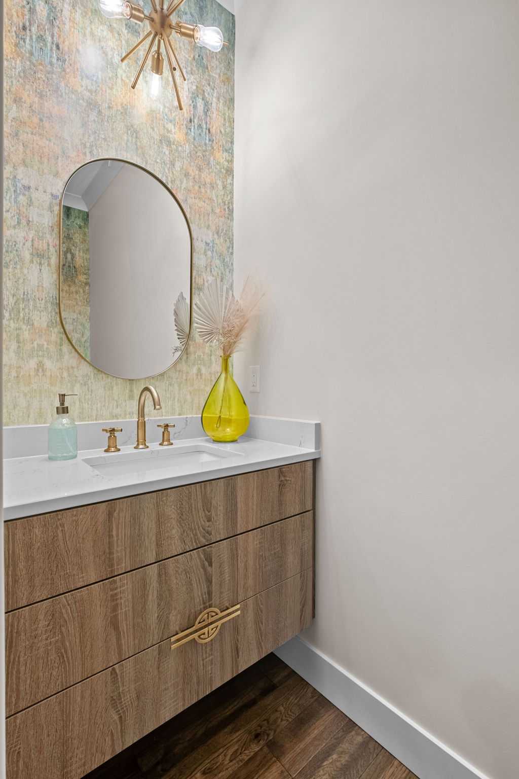 The shared half bathroom on the main floor features modern wallpaper and additional contemporary touches.