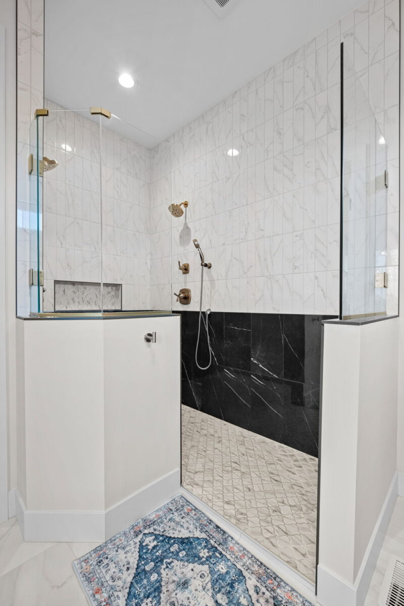 A contemporary, modern shower with full custom tiling.