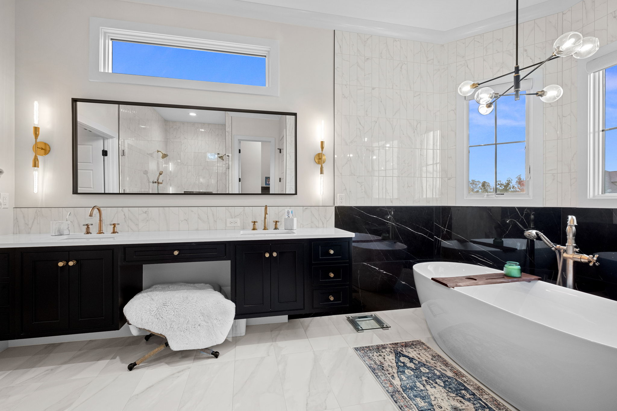 A luxurious, modern tiled bathroom featuring a soaking tub.
