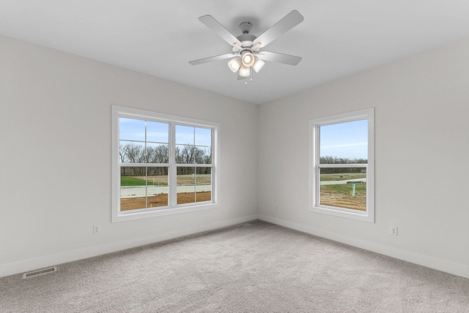 Bedroom number two features a softly-hued carpet and provides access to the Jack and Jill bathroom.