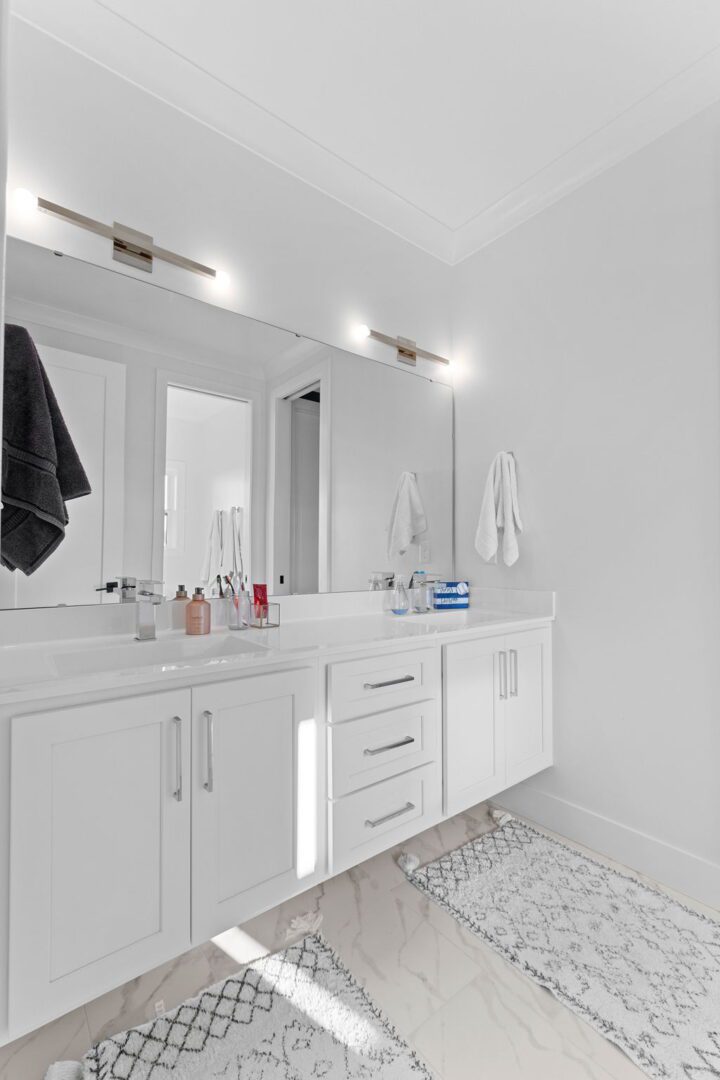 Shared bathroom with double floating vanity.