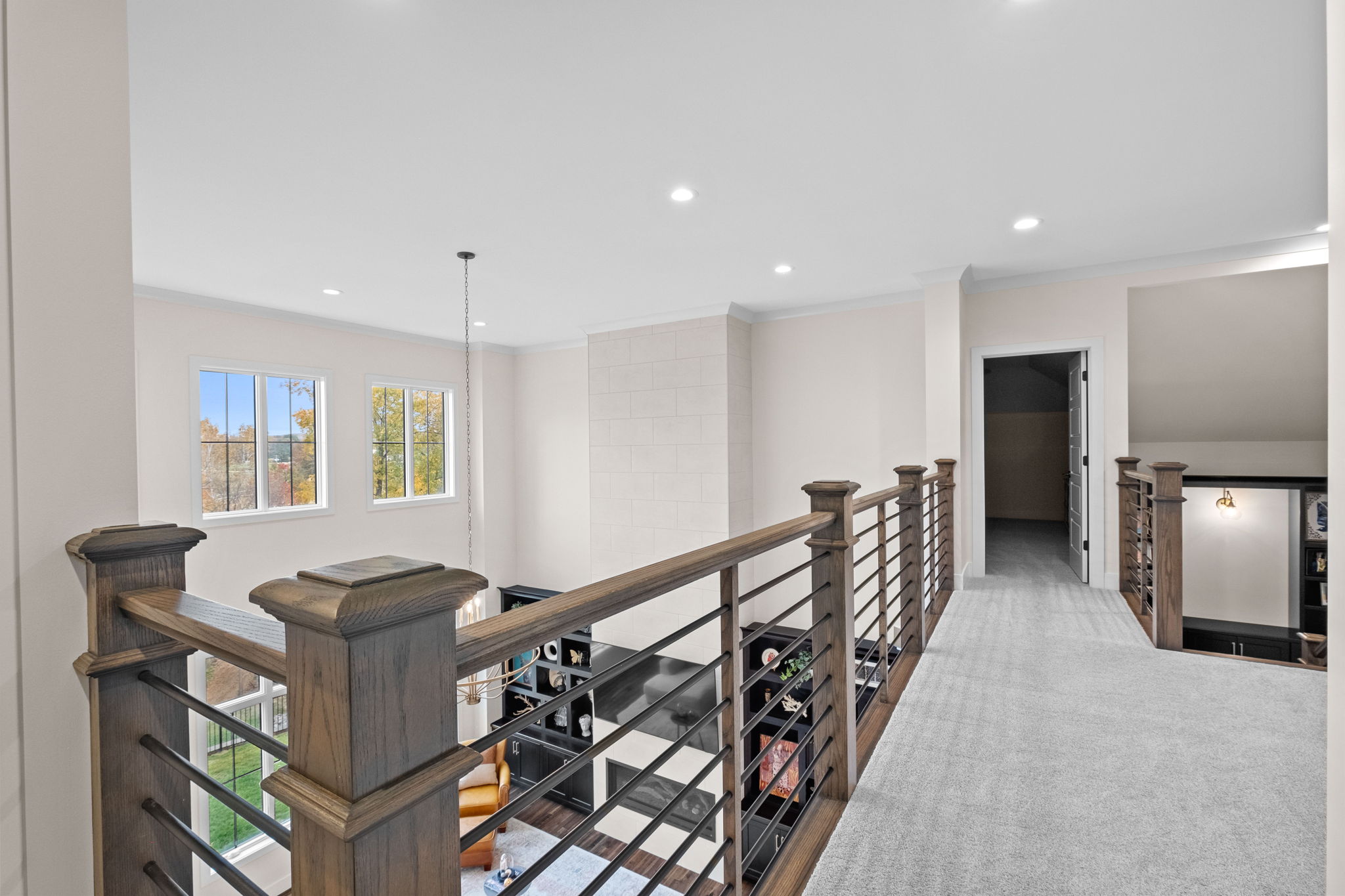 The second-floor walkway leads to the three upstairs bedrooms and the playroom.