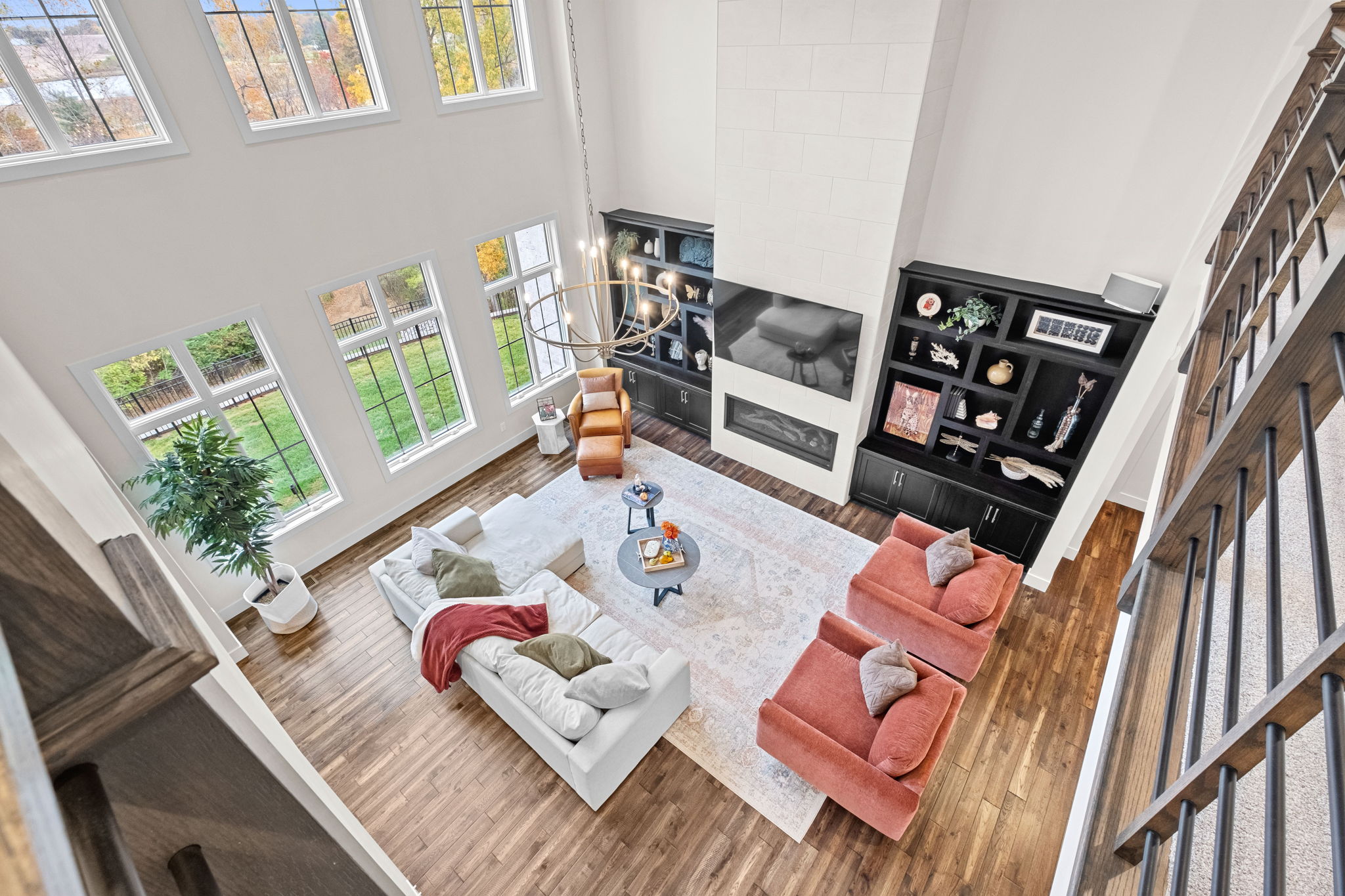 A great room boasts 14+ foot ceilings and a large, two-story tiled fireplace.