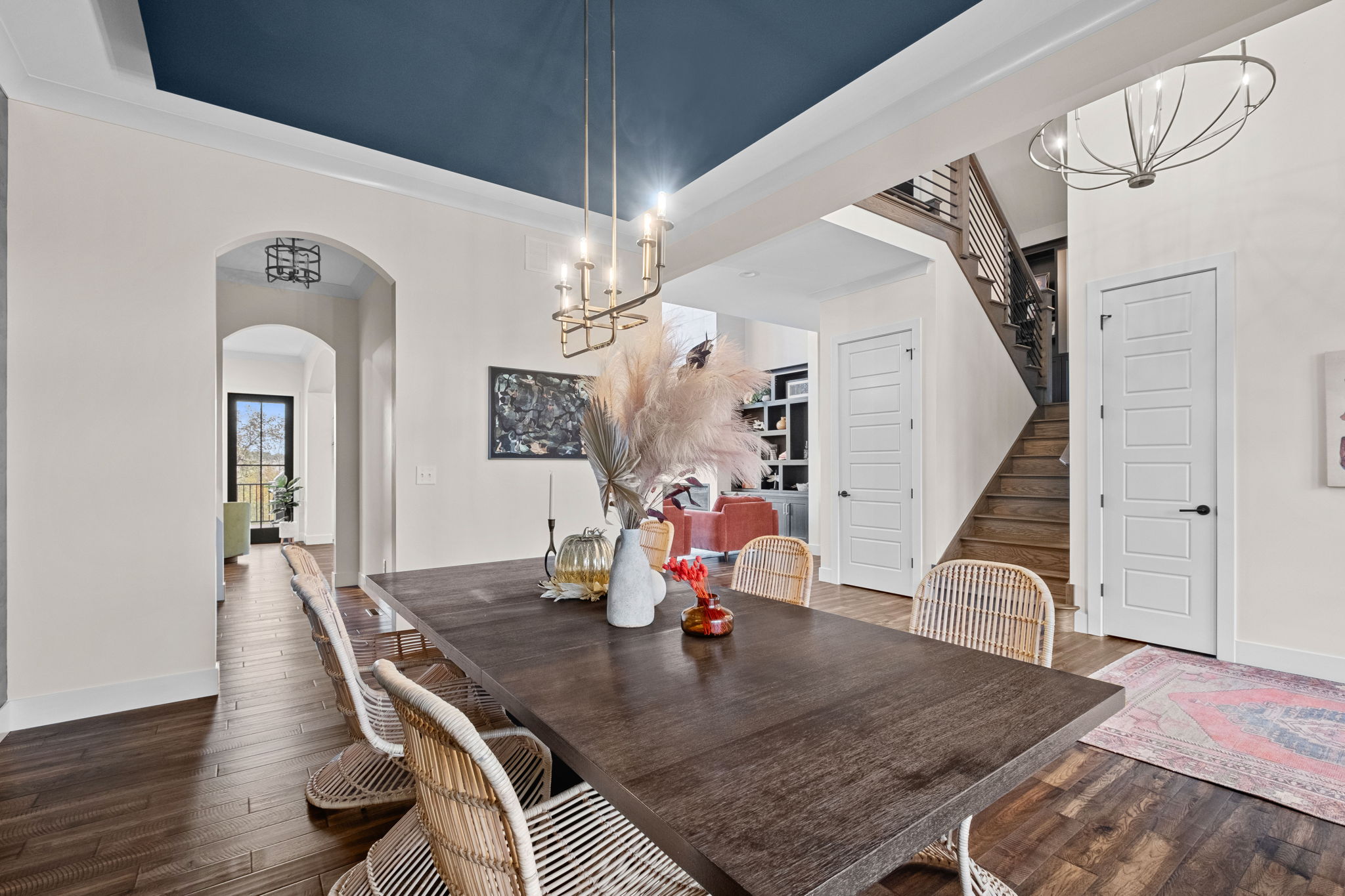 A formal dining room adorned with a drop ceiling and wallpaper custom-designed by the homeowner.