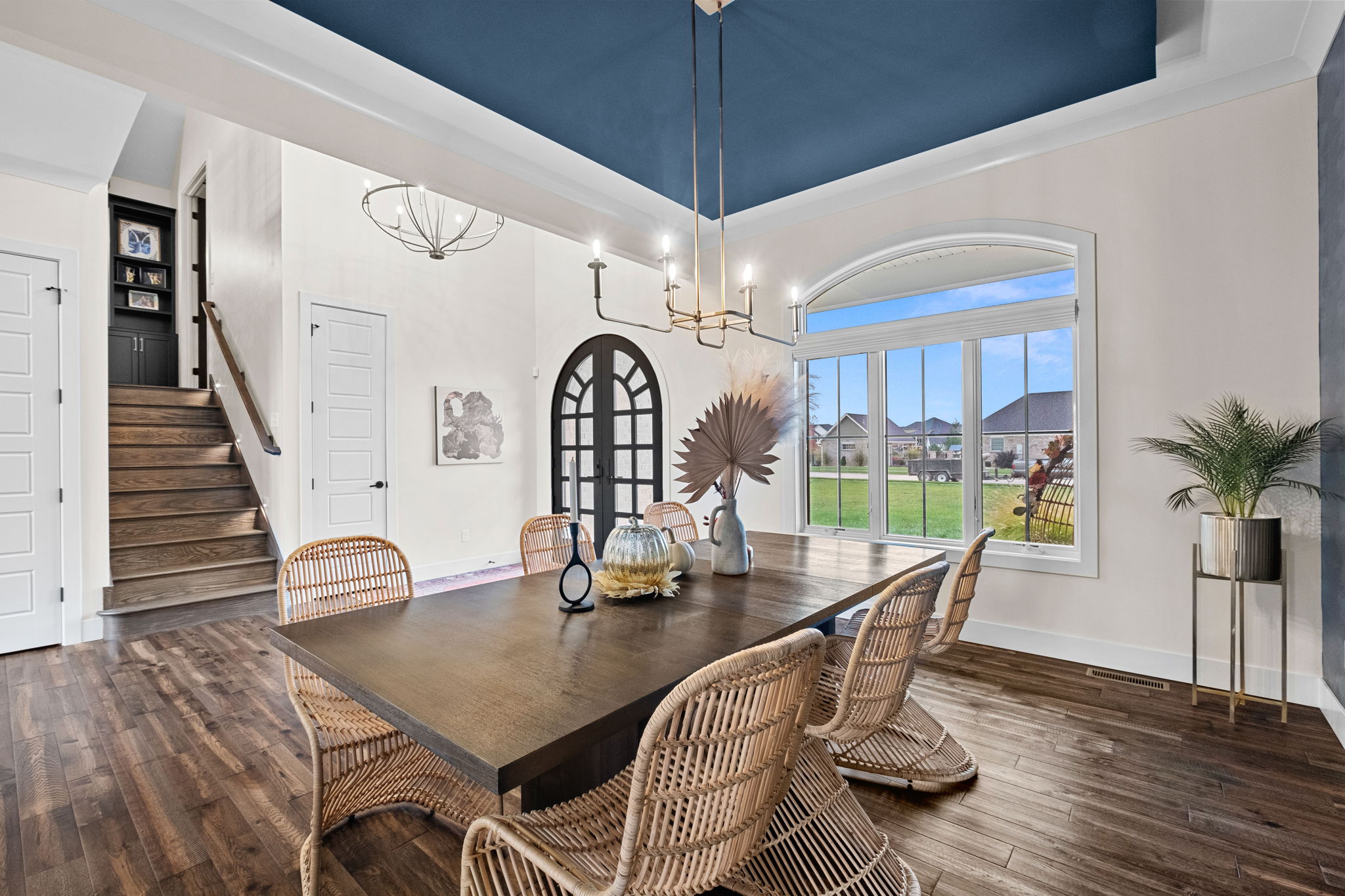 A formal dining room adorned with a drop ceiling and wallpaper custom-designed by the homeowner.