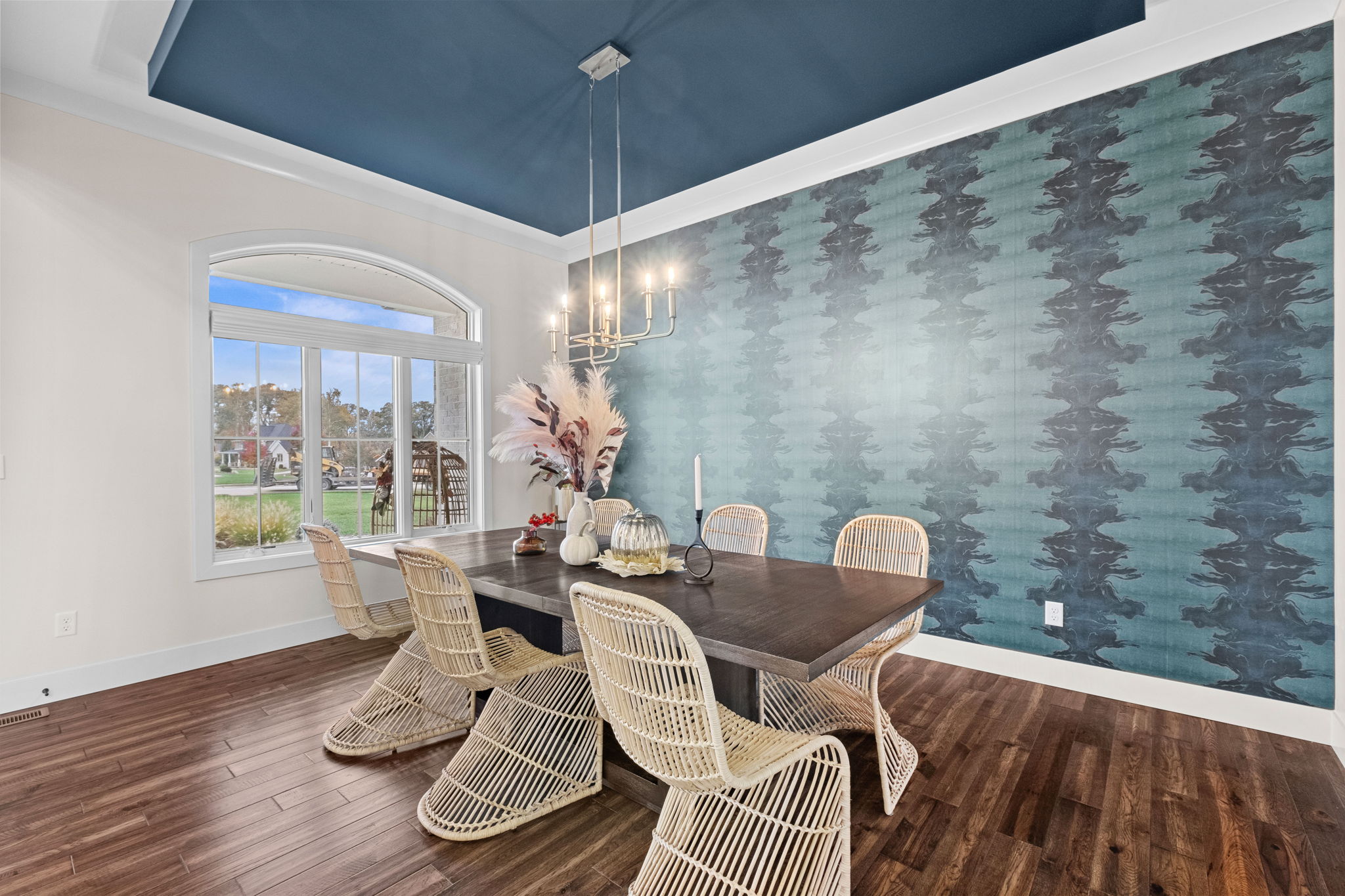 A formal dining room adorned with wallpaper custom-designed by the homeowner.