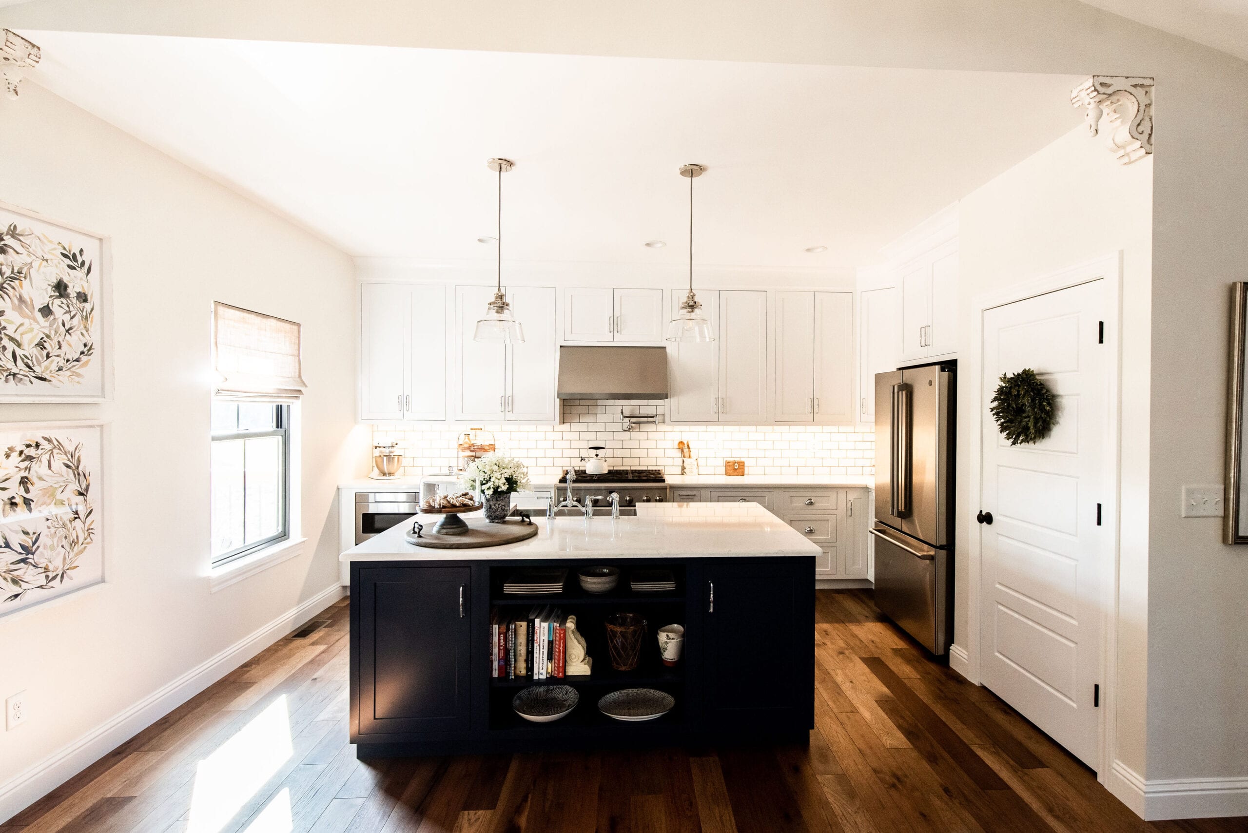 An elegant, modern farmhouse with an open floor plan features a kitchen that seamlessly transitions into the dining room and great room. pioneer ridge