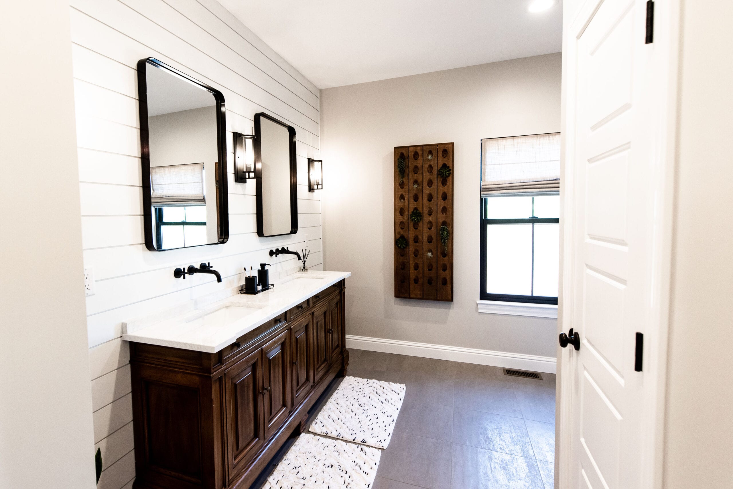 A primary bathroom featuring rustic elements and a shiplap wall design.
