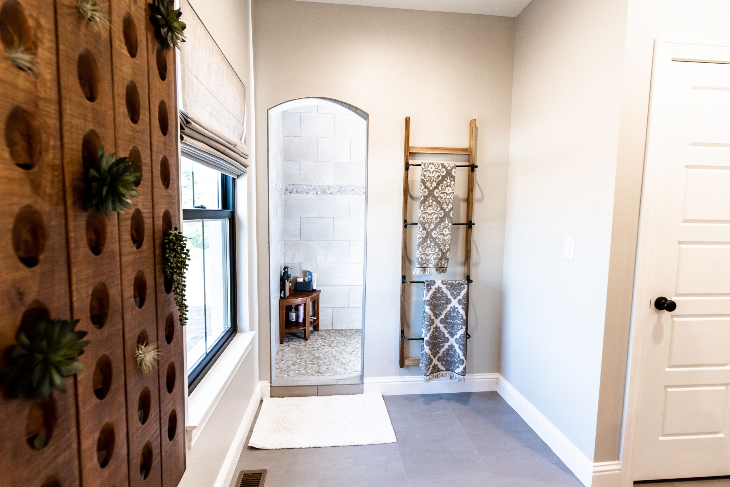 A primary bathroom featuring rustic elements and a walk in shower.