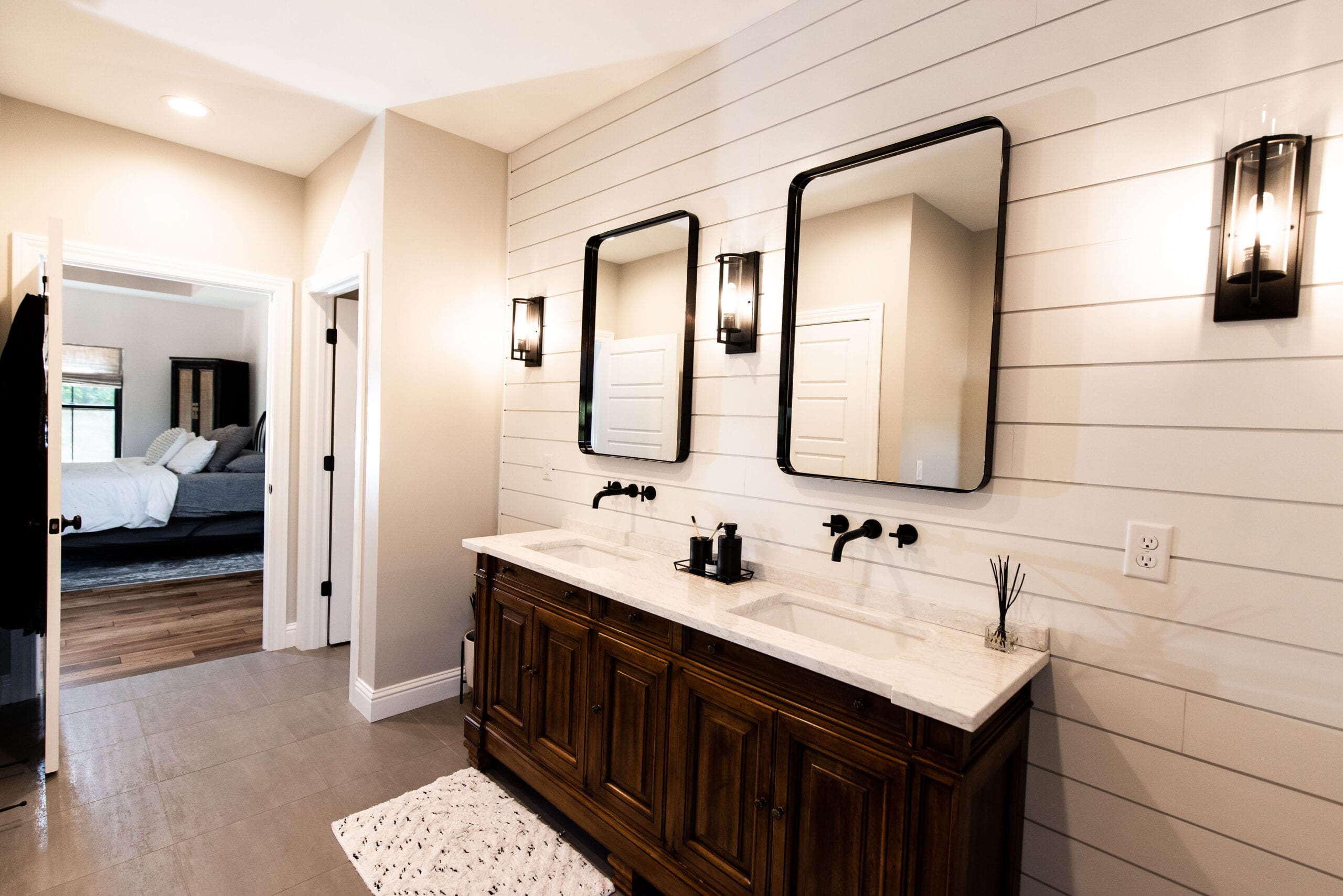 A primary bathroom featuring rustic elements and a shiplap wall design.