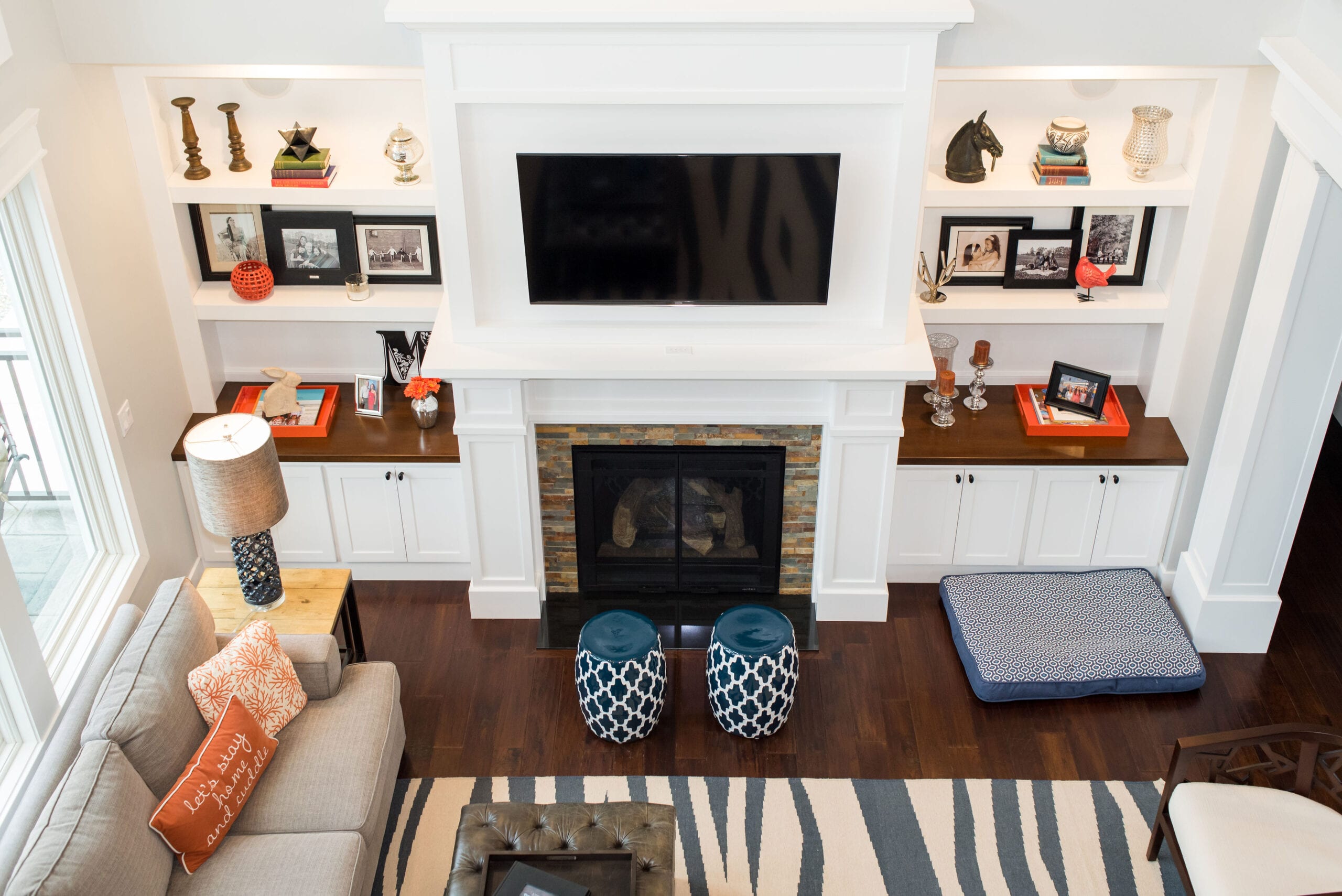Custom built-in cabinets and fireplace view from second story balcony.