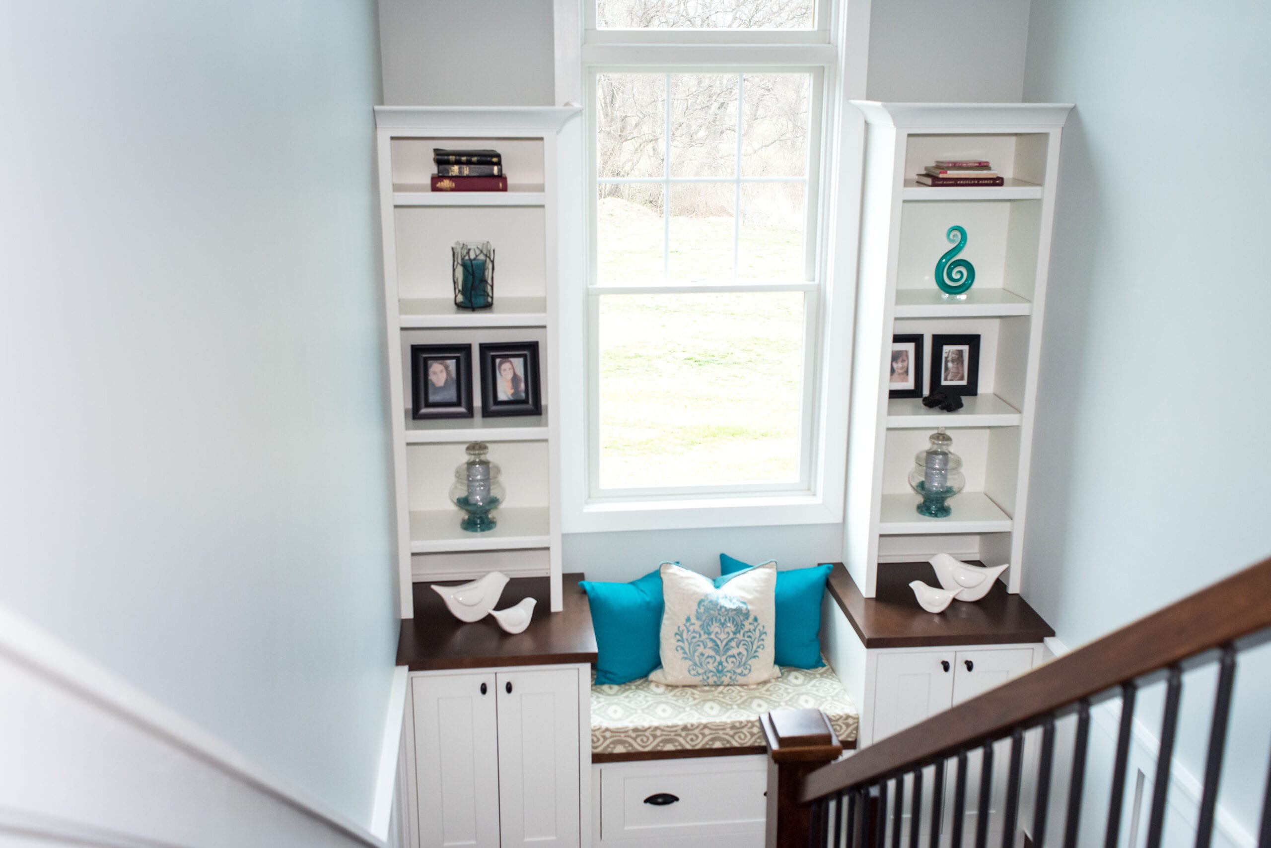 Custom built-in cabinets in landing view from second story balcony.