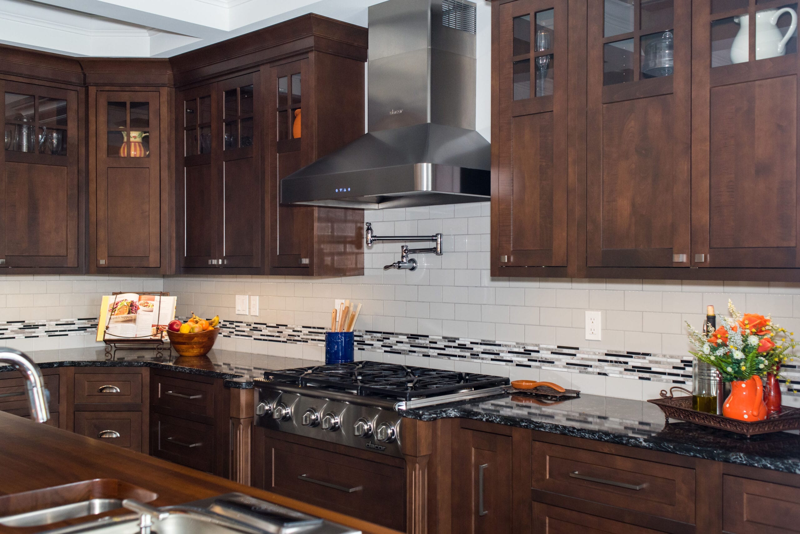A Craftsman-style kitchen featuring luxurious, dark-stained custom cabinets.