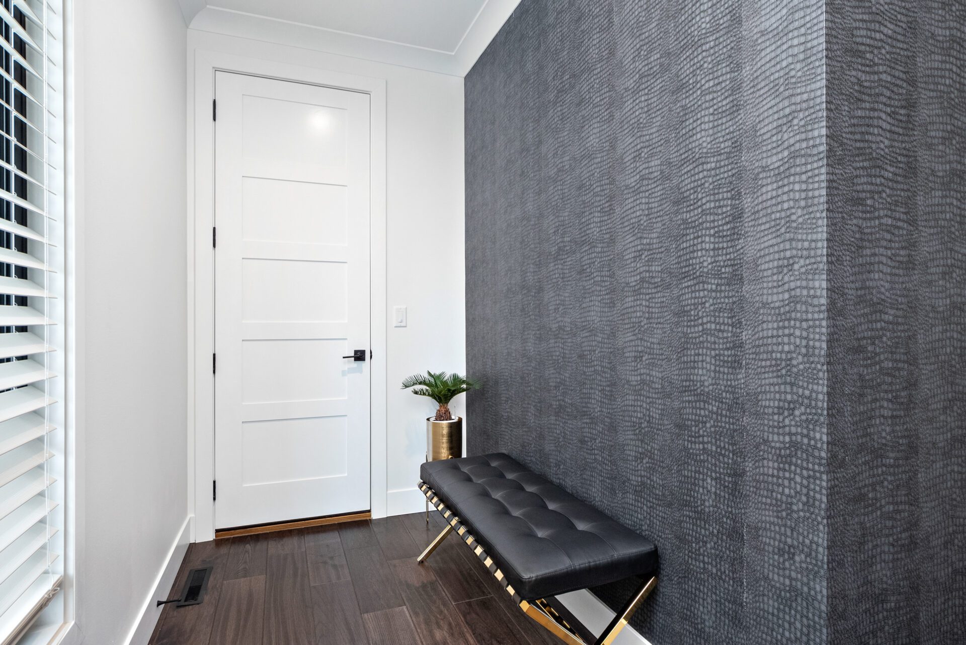 Garage entry and drop zone featuring textured alligator wallpaper.