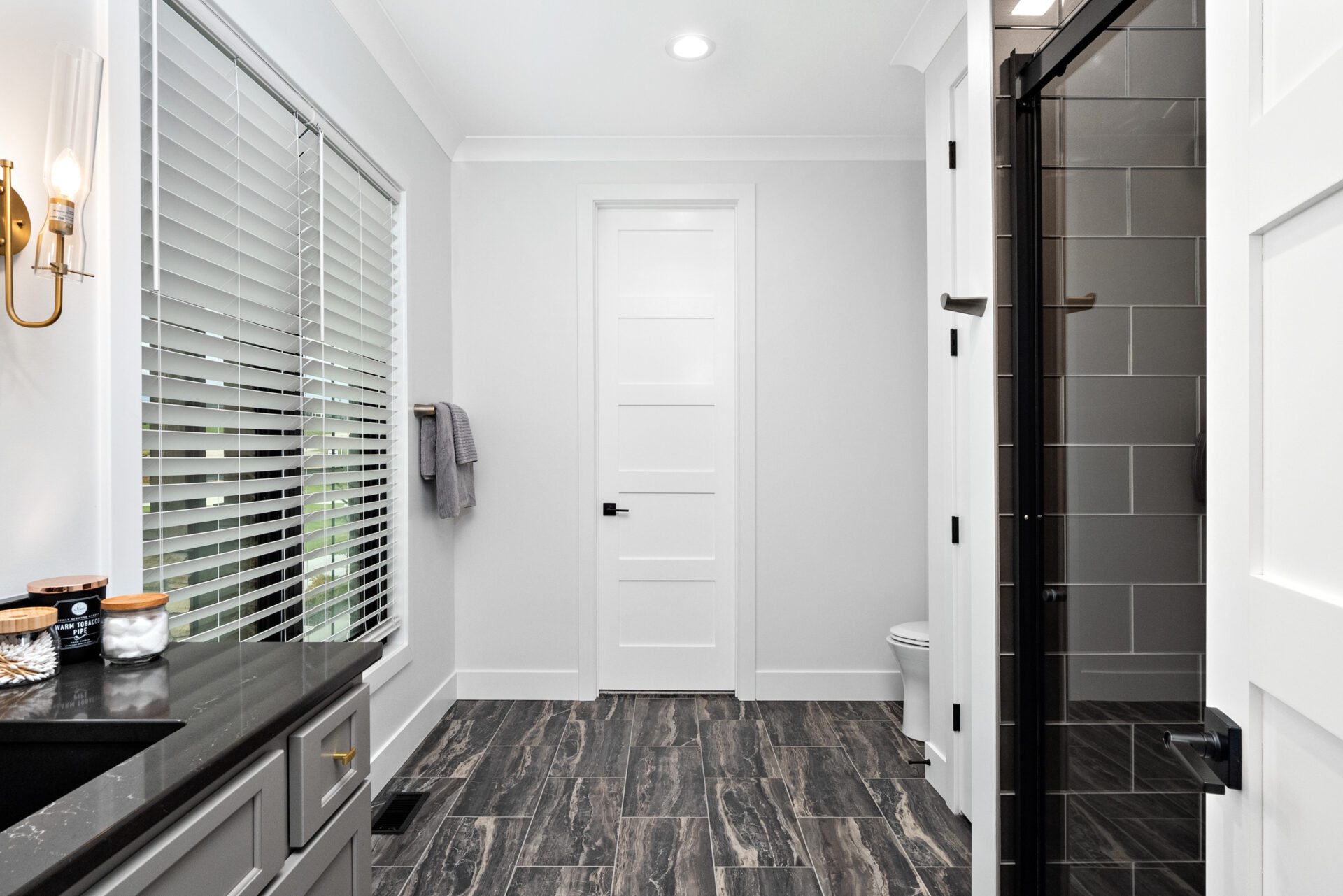 Bedroom two features an en-suite bathroom with a glass-tiled shower.